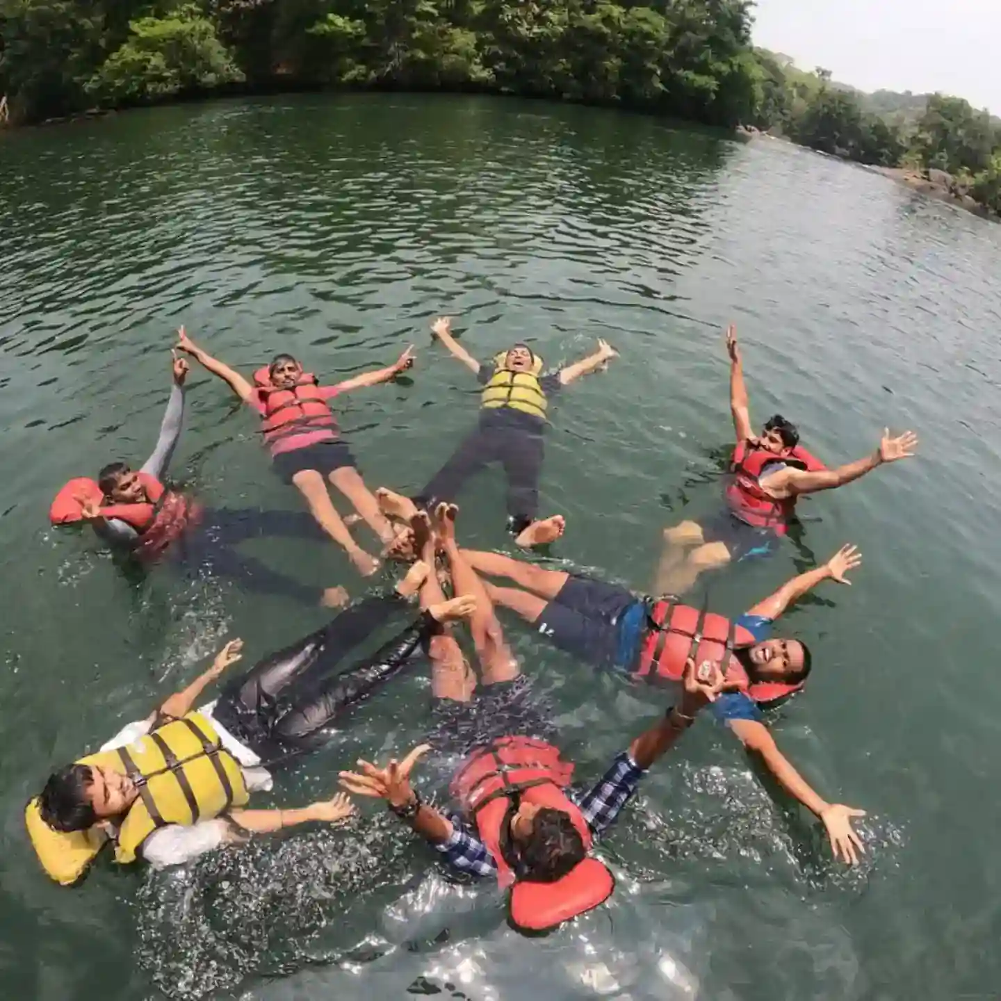 Rafting group enjoying white water rapids with splashing water on Kali River, Dandeli