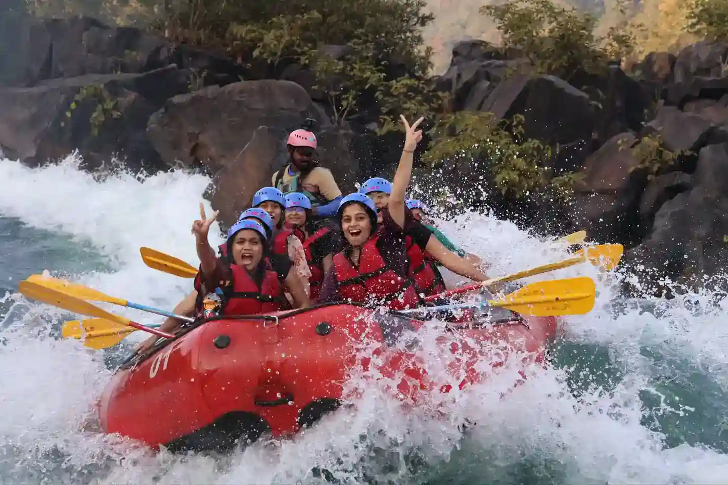 Rafting group hitting rapids with dramatic splash on Kali River, Dandeli
