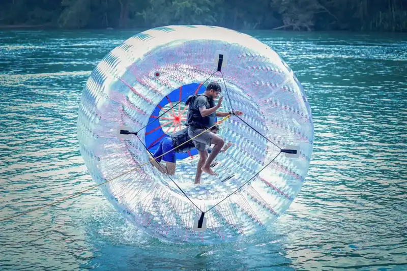 Couples enjoying fun water zorbing activity on Kali River in Dandeli