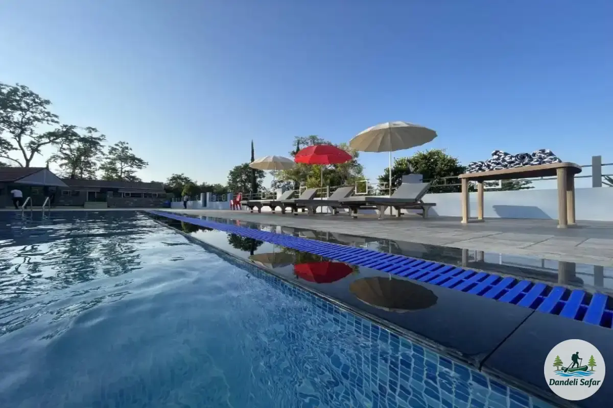 Outdoor swimming pool during daytime with clear water at B Hive Resort Londa