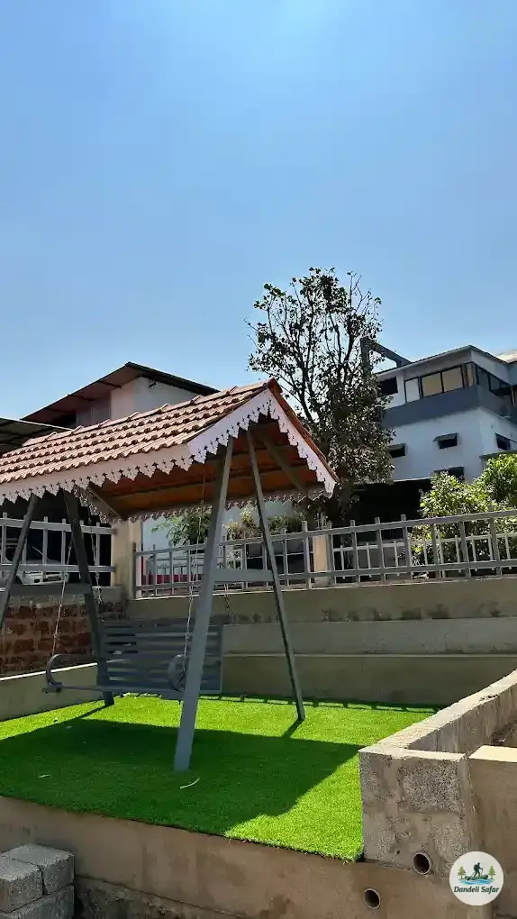 Outdoor garden dining area surrounded by greenery at B Hive Resort Londa