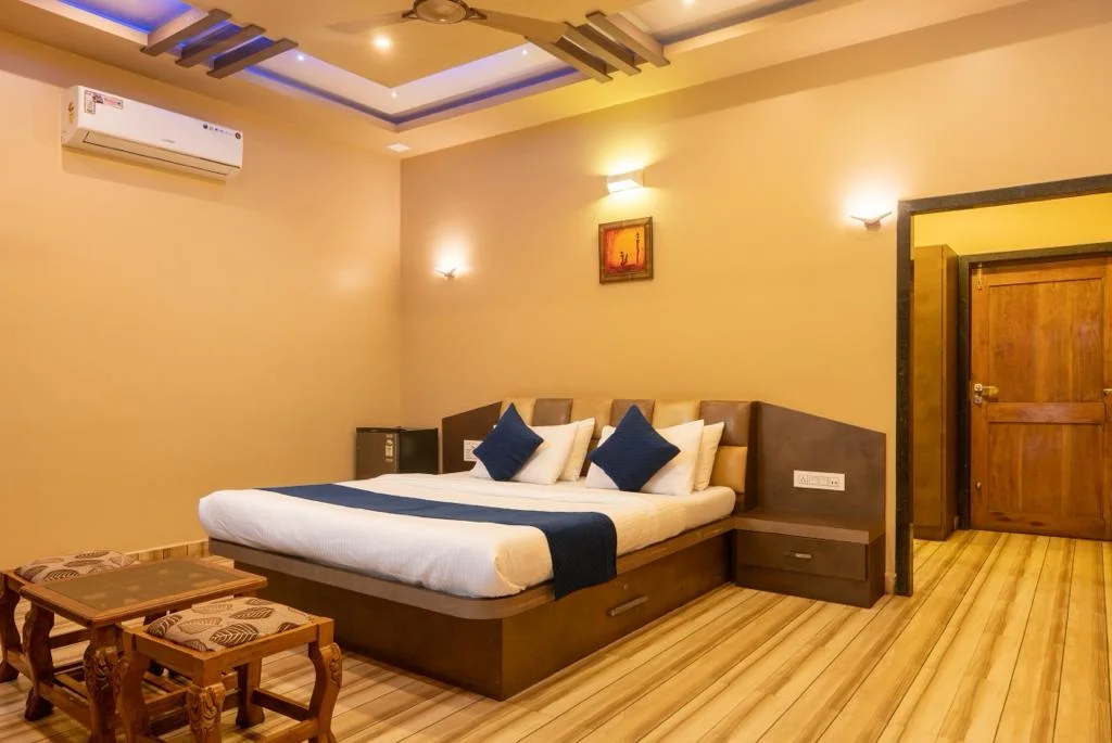 AC Deluxe room with modern amenities and comfortable bedding at Dew Drops Jungle Resort