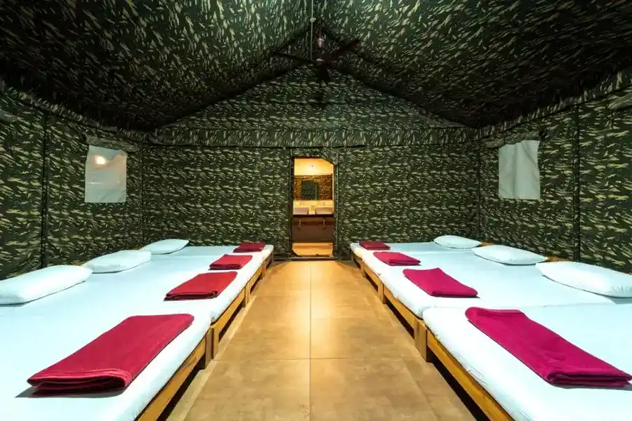 Comfortable commando cottage interior with basic amenities at Dew Drops Resort