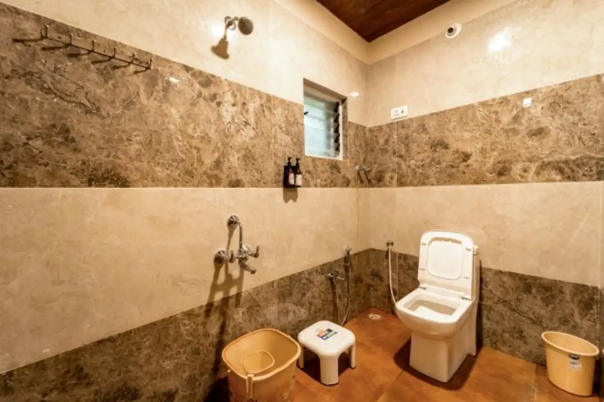 Clean attached washroom in AC Deluxe room at Rain Forest Resort