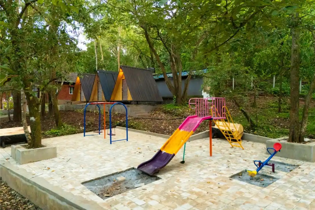 Kids play area with swings at Rain Forest Resort Dandeli