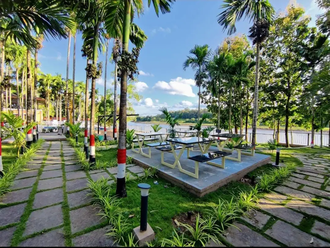 Riverside seating with sunset view at River Edge Retreat Dandeli