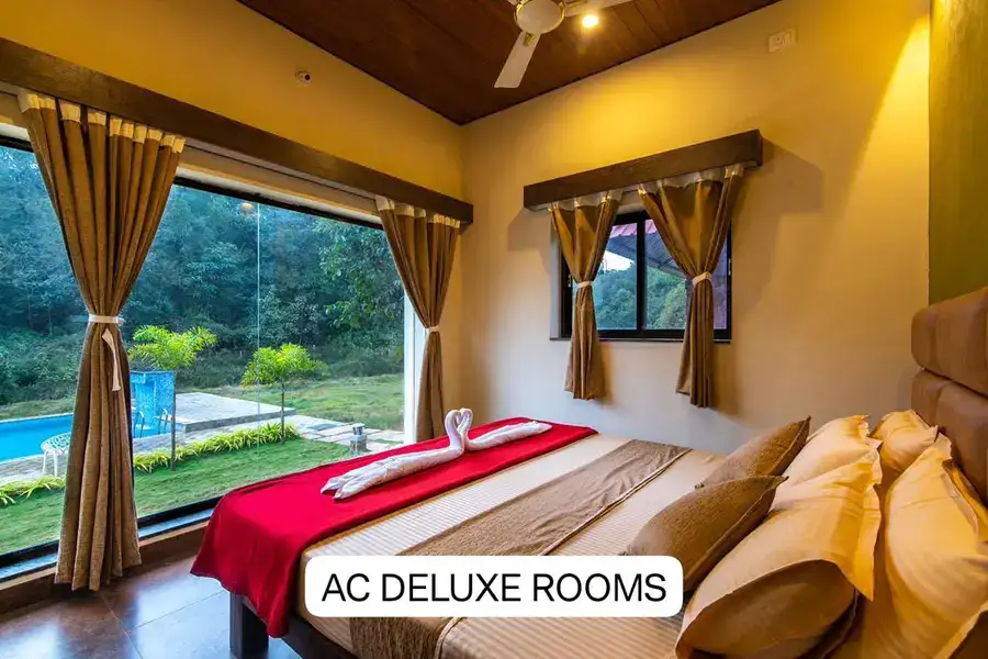 AC Deluxe room with scenic forest and pool view at Tusker Trails Dandeli
