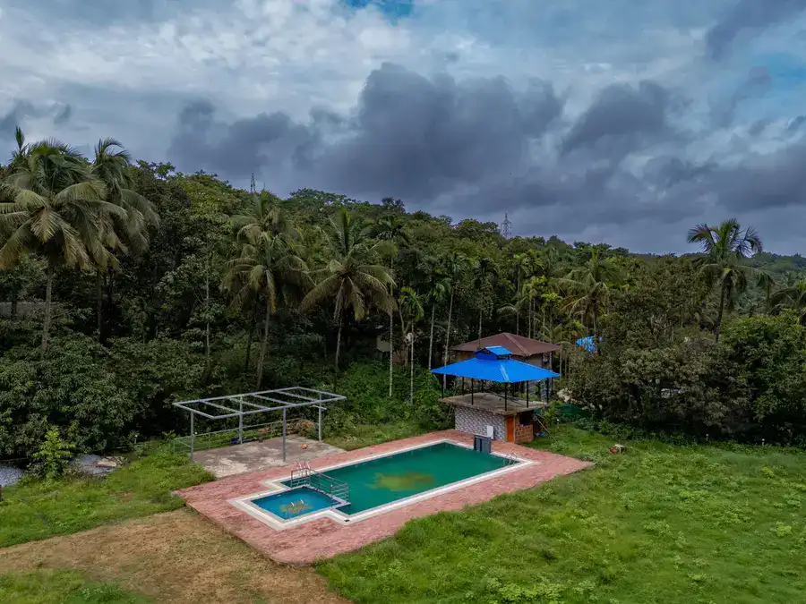 Swimming pool at Tusker Trails with open sky view surrounded by nature