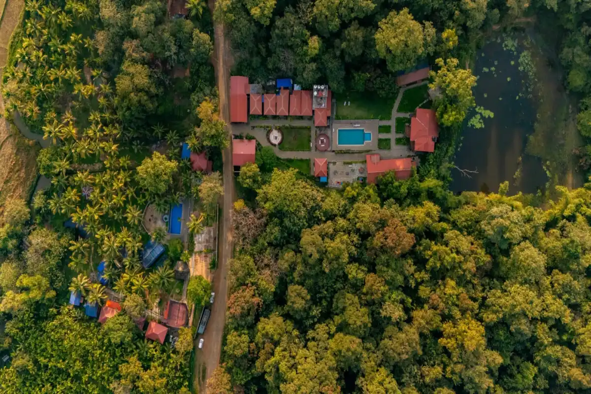 Top-down aerial view of Wild Mist resort layout surrounded by forest in Dandeli