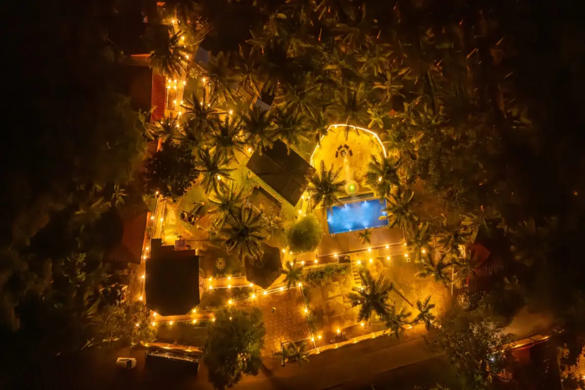 Aerial perspective of Wild Mist resort at night showing pool and cottages