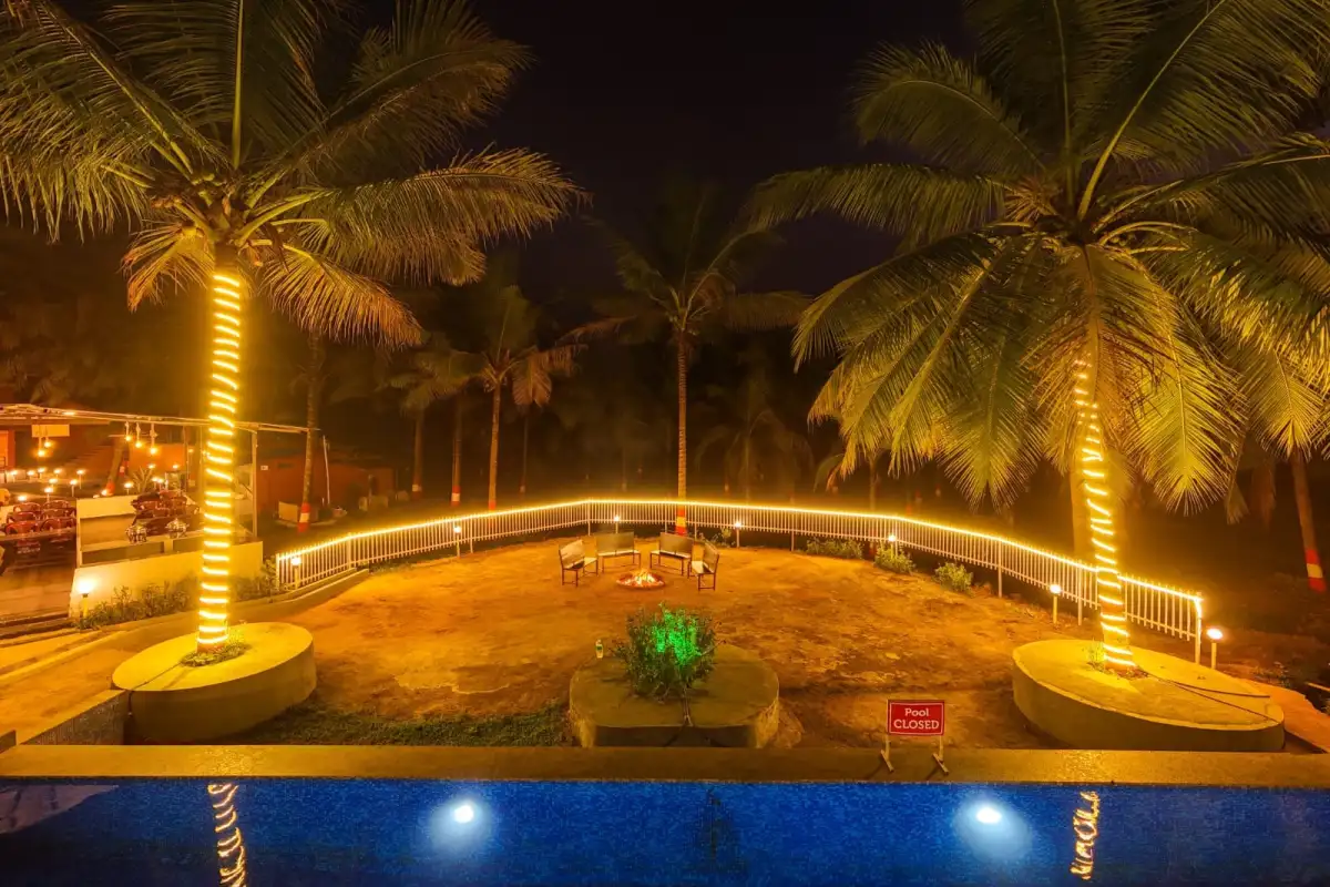 Illuminated swimming pool at Wild Mist resort Dandeli with night ambiance